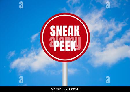 Sneak peek message written on red round sign on blue sky background. Conceptual sneak peek symbol. Copy space. Stock Photo