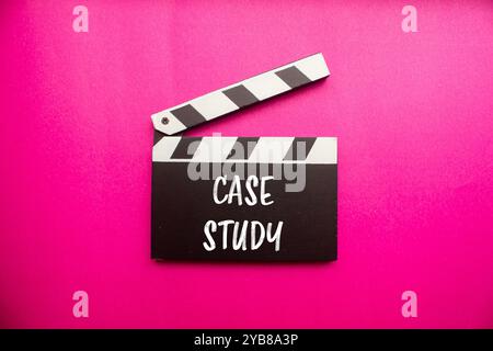 Case study message written on clapperboard with pink background. Conceptual case study symbol. Copy space. Stock Photo