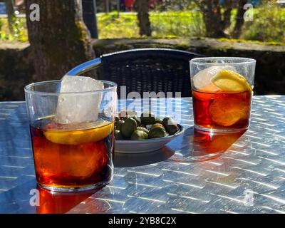 Two glasses of wermouth with green olives in a terrace. Spain. Stock Photo