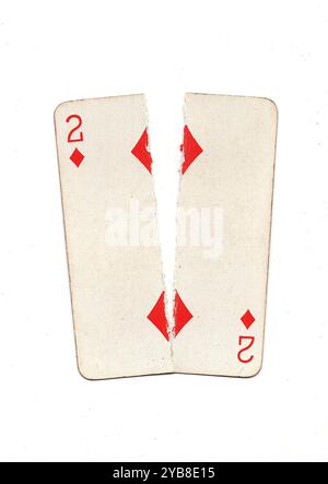 A vintage playing card torn in half from top to bottom on a white ...