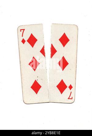 A vintage playing card torn in half from top to bottom on a white ...