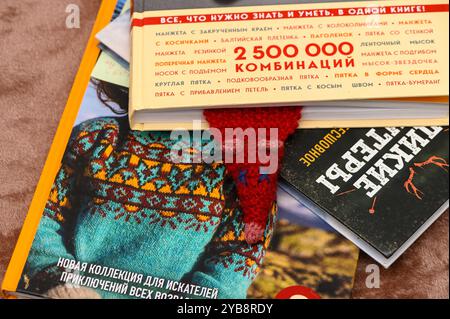 A vibrant display of various books features intricate designs and a handmade bookmark peeking through, inviting readers to explore new adventures and Stock Photo