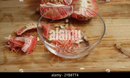 Sliced Pomelo on Wooden Surface Showcasing Juicy Texture Stock Photo