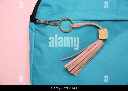 Backpack with leather keychain on pink background, top view Stock Photo