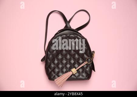 Backpack with leather keychain on pink background, top view Stock Photo