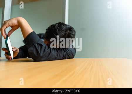 Closeup hand of relaxed man using smartphone Stock Photo