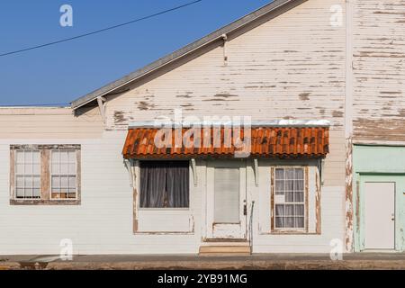 Yoakum, Texas, United States. March 17, 2022. Rusted metal awning on an old building with peeling paint. Stock Photo