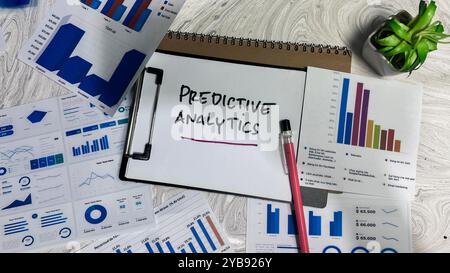 Concept of Predictive Analytics write on paperwork isolated on wooden background. Stock Photo