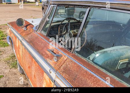 Yoakum, Texas, United States. March 17, 2022. An old rusted Chrysler car in a Texas junkyard. Stock Photo