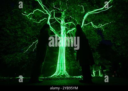 People look up at the 'Carnivorous Tree' on the Halloween trail at the