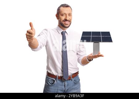 Professional man holding a small solar panel model and gesturing thumbs up isolated on white background Stock Photo
