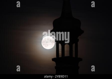 Prague, Czech Republic. 17th Oct, 2024. Supermoon seen with historical tower in the Czech capital Prague. October's full moon, also known as the Hunter's Moon is biggest and brightest supermoon in this year. Credit: SOPA Images Limited/Alamy Live News Stock Photo