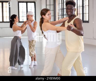 Four dancers exercising bachata movements Stock Photo