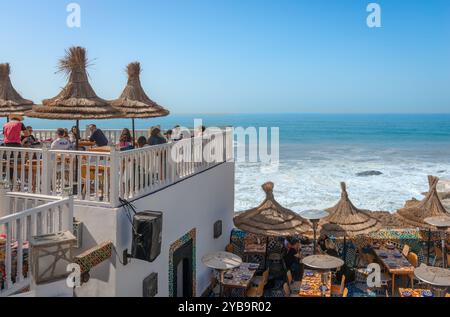 Essaouira, Morocco - February 19 2024: People on a roof terrace bar-restaurant enjoy a breathtaking view of the Atlantic Ocean. Stock Photo