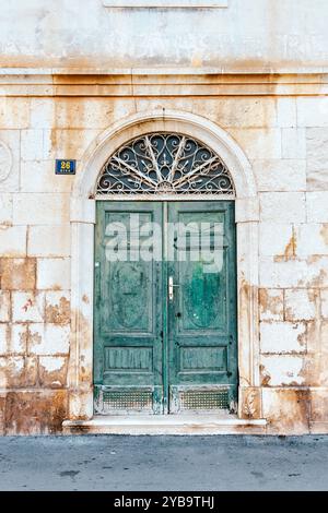 Arched doorway with fanlight at a villa in the village of Milna on the Adriatic Sea, Brac, Croatia Stock Photo