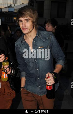 LIAM PAYNE from ONE DIRECTION X Factor contestants seen leaving a Gym in Covent Garden, London, England, UK, 24th November 2010. half length diesel denim blue shirt brown trousers hand in pocket bottle of coke drink CAP/IA © Ian Allis/Capital Pictures/MediaPunch *** USA ONLY** Stock Photo