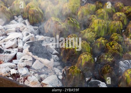 Artichokes being grilled on charcoal Stock Photo