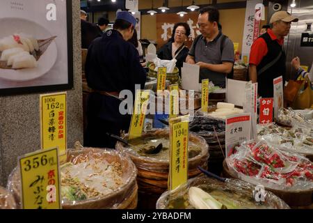 A customer buying traditional Japanese pickles from a pickle vendor in Nishiki Market.Kyoto,Japan Stock Photo