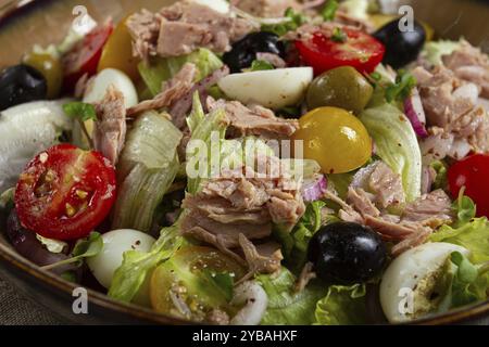 Salad with canned tuna, vegetable salad with quail eggs, lettuce, red onion, cherry tomatoes, olives, keto food, healthy food, homemade, no people Stock Photo