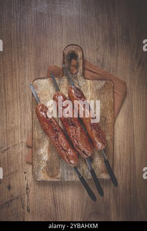 Fried sausages, in English with bacon, for grilling, on a cutting board, top view, no people Stock Photo