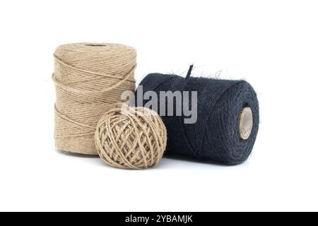 A collection of jute and twine spools on a white background, highlighting natural fiber materials ideal for various crafting and packaging needs. Stock Photo