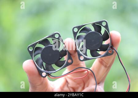 Computer cooling fans used in cpu. CPU cooler fans held in the hand Stock Photo