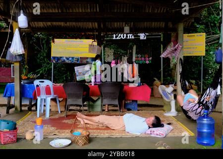 Female restaurant worker taking a nap after lunch hour in a restaurant in Blue Lagoon1 near VANG VIENG, Laos Stock Photo
