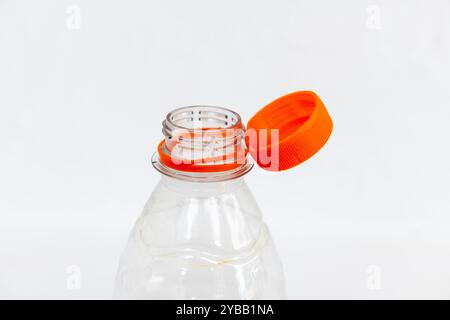 A cap attached to a plastic bottle conforming to the new EU Bottle Cap Requirement, isolated on a white background. Stock Photo