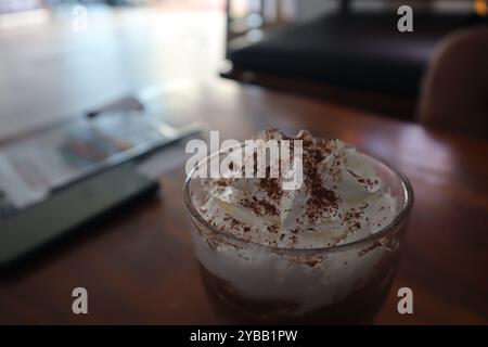 Iced chocolate with whipped cream on wooden table Stock Photo