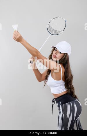 Portrait of a young badminton player isolated on gray background. Stock Photo