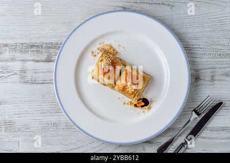 Traditional Turkish dessert walnut baklava on a white porcelain plate Stock Photo