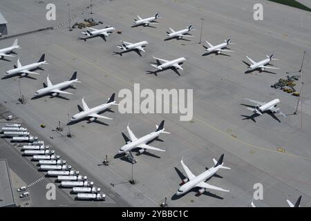 High angle view airplanes parked on sunny airport tarmac Stock Photo