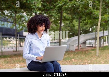 female entrepreneur working remotely on laptop Stock Photo