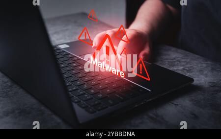 System hacked warning alert on laptop. Virus, Spyware, Malware or Malicious software. Woman receives warning notification on laptop. Stock Photo