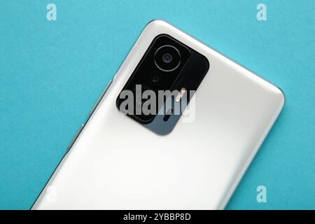 Mobile phone camera, flash lens on blue background. Top view Stock Photo