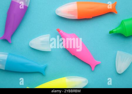 Colored markers for highlighting text on blue background. Space for text. Top view Stock Photo