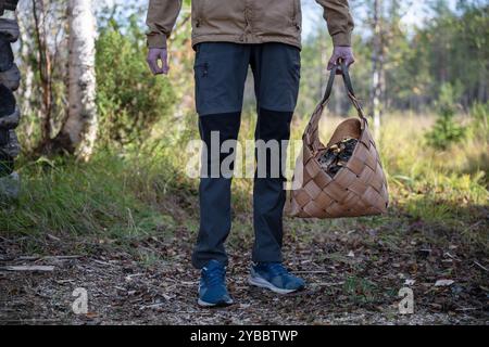Man with firewood in basket Stock Photo