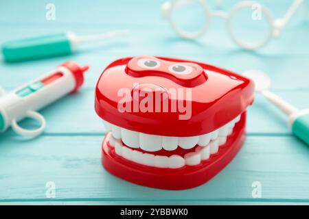 Model toys teeth with dentist instrument on blue background. Top view Stock Photo