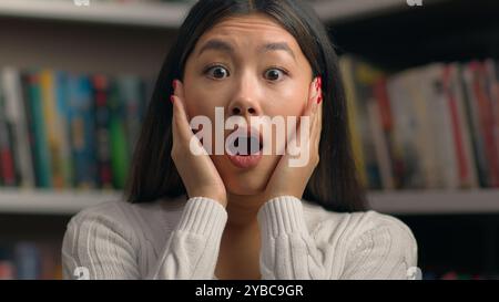 Close-up surprised young asian woman in shock with frightened expression opens mouth shocked by bad news feeling stress female student teacher Stock Photo
