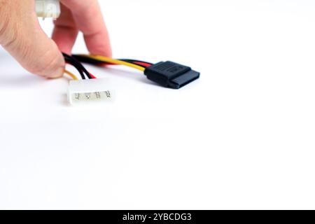 Hand holding IDE to Sata connector adapter on white background Stock Photo