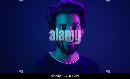 Portrait Indian man standing in profile side view turn to camera smiling toothy happy guy developer coding smile computer internet technology hacker Stock Photo