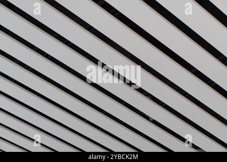 Lights and ventilation system in long line on ceiling of the industrial building. Exhibition Hall. Ceiling factory construction Stock Photo