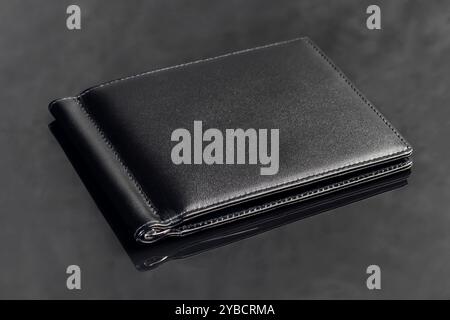 Black leather men's wallet for storing money and cards. On a dark background. Copy space Stock Photo