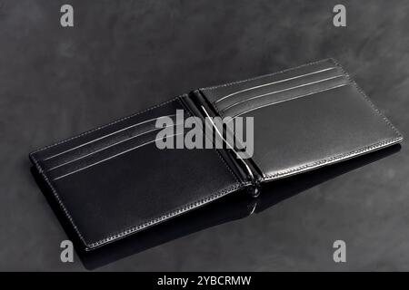 Black leather men's wallet for storing money and cards. On a dark background. Copy space Stock Photo