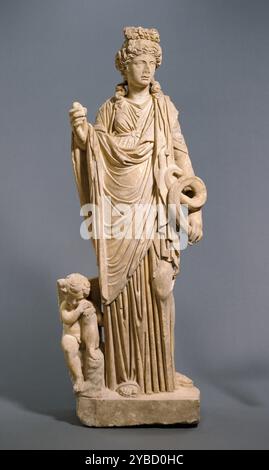 Statue of Salus, A.D. 200-250.  Additional Info: Standing with her weight on one leg and clothed in a voluminous gown, this statue of a goddess looks off to her left. The figure displays elements connected with both Hygieia, the goddess of health, and Aphrodite, the goddess of love. The presence of the small, sleeping Eros, the winged young god of love, who leans against her leg, and the goddess's knotted bow hairstyle argue in favor of her identity as Aphrodite. Yet the dress the goddess wears and the snake she holds are more typical of Hygieia. Furthermore, the egg she holds, an emblem of Hy Stock Photo