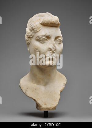 Portrait Bust of Livia, A.D. 1-25.  Additional Info: Preserved is a portrait bust of Livia (b. 58 B.C. d. A.D. 29), wife of Emperor Augustus, and mother - by her previous marriage - of Tiberius. Her oval face is smooth and full, with large eyes that have distinct upper and lower lids, a small mouth and a round chin. The back and the left side of the head are missing, and there is damage to her nose and mouth, as well as chips on the right side of her face. She wears her hair in the nodus style - a three-inch section on top of her head is drawn forward to form a knot (nodus) and then braided ba Stock Photo