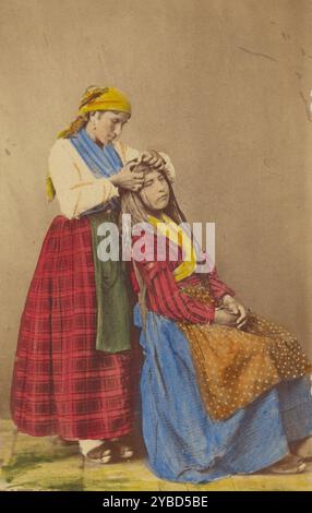 Older woman doing the hair of a younger woman., about 1870. Stock Photo