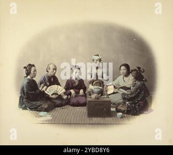 Japanese Singers, about 1868. A group of men and women sit around a brazier with a tea kettle on top. A woman plays a  shamisen, while others in the group clap. One man holds an open fan in his lap, another is heavily tattooed on his upper body. Stock Photo