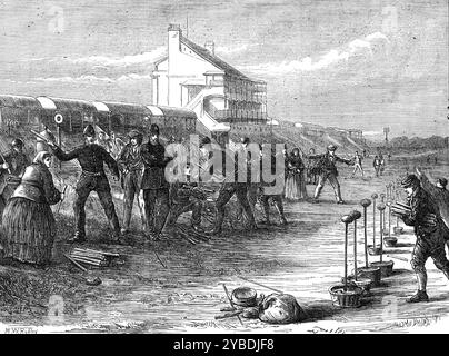 Eve of the Derby: at the winning-post, 1871. 'The annual summer meeting of English horse-lovers [ie the Derby Stakes, for three-year-old colts and fillies], on the breezy downs of Epsom [in Surrey] is nigh at hand...[Our illustration shows one of] the scenes usually to be witnessed a few hours earlier than &quot;the great event,&quot;...The gathering of a motley multitude of people - men, women, and children - intending to earn, or to beg, or perhaps to steal, or to gain by cheating, or to win by any means whatever, a few shillings from the careless and unwary, whose pockets are better filled. Stock Photo