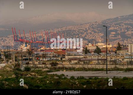 The port cranes at Beirut port terminal, with city panorama, mountains and building, Lebanon. Stock Photo